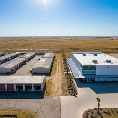 Aerial view of golden Texas plains under a blazing sun and bright blue sky, showing the intense summer heat and dry land.